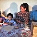 young boy saving as part of a savings group in Guatemala