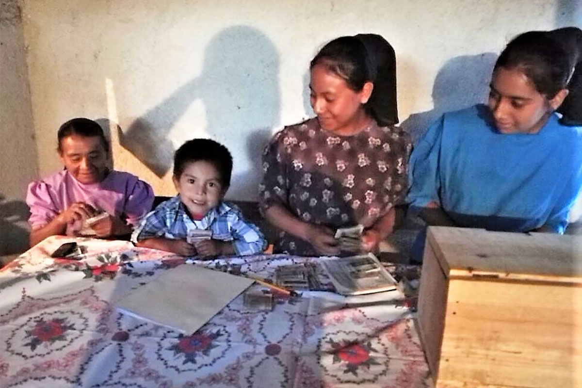 young boy saving as part of a savings group in Guatemala