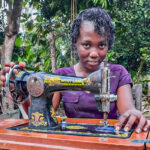 savings group member saves to buy a sewing machine