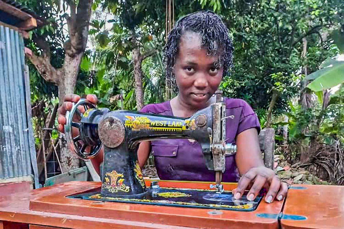 savings group member saves to buy a sewing machine