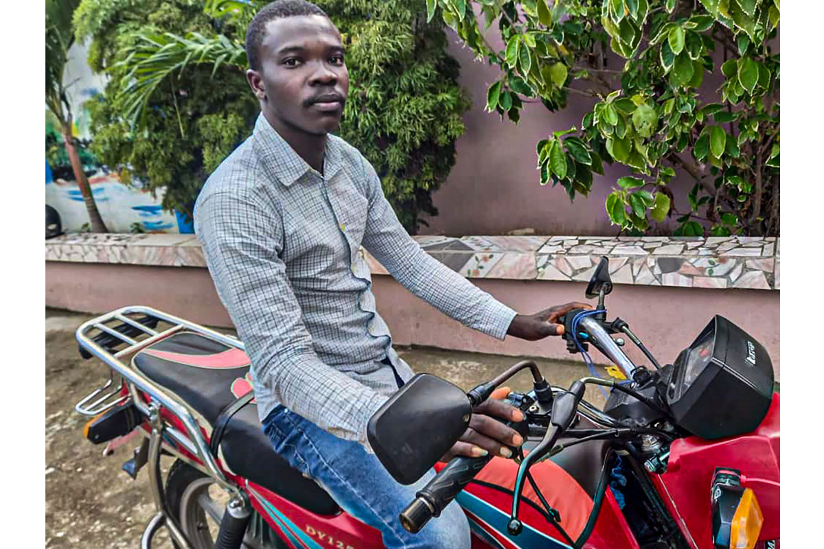 savings group member in Haiti buys motorcycle with savings