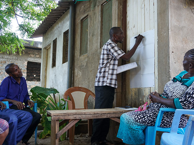 Savings group facilitator teaching habits of saving