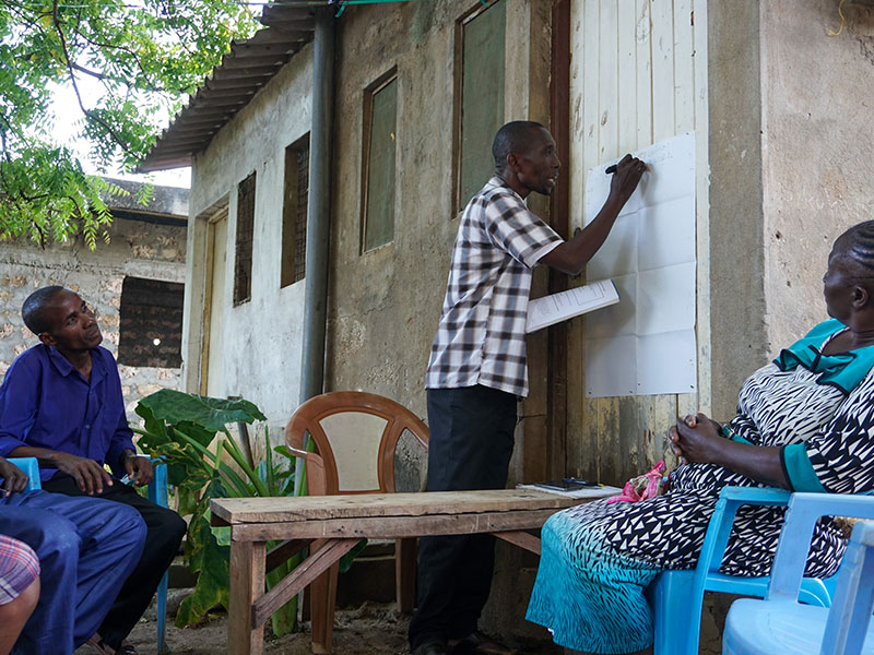 Savings group facilitator teaching habits of saving